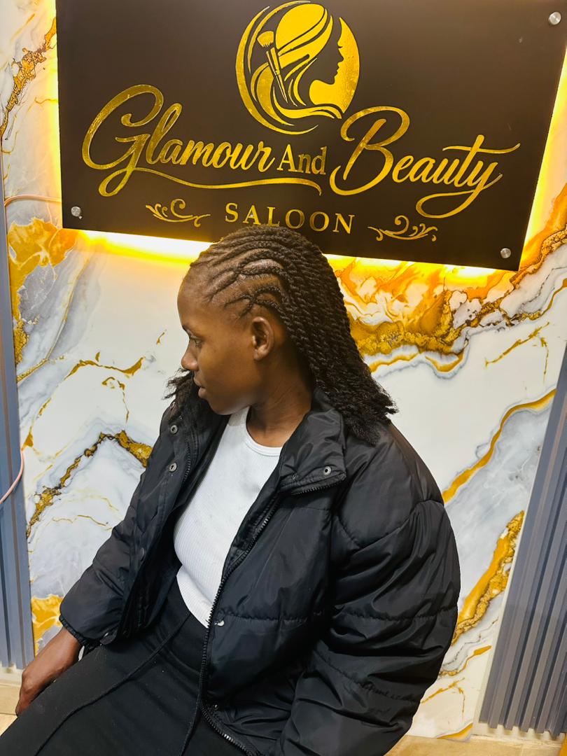 A neat side-swept cornrow twist style.